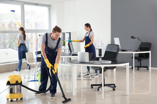 team of janitors cleaning office